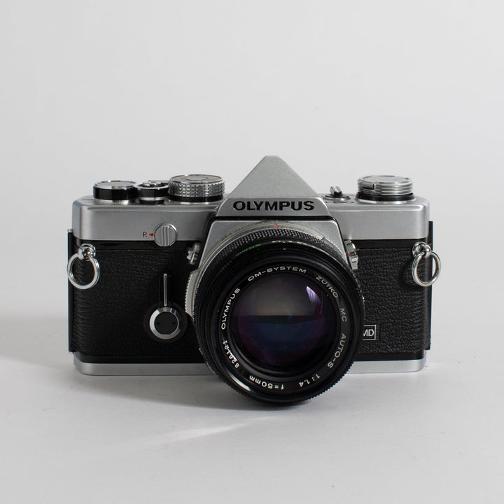 Olympus OM-1 with 50mm f/1.4 lens and leather case (film tested)