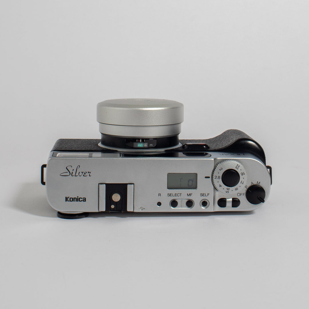 Konica Hexar Silver with 35mm f2 lens, leather case, and strap